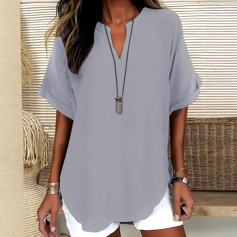 Blusa de manga corta holgada de color liso a la moda.